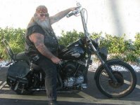 A-photograph-depicting-a-fat-American-biker-riding-on-his-Harley-Davidson-as-he-wears-stupid-loo.jpg